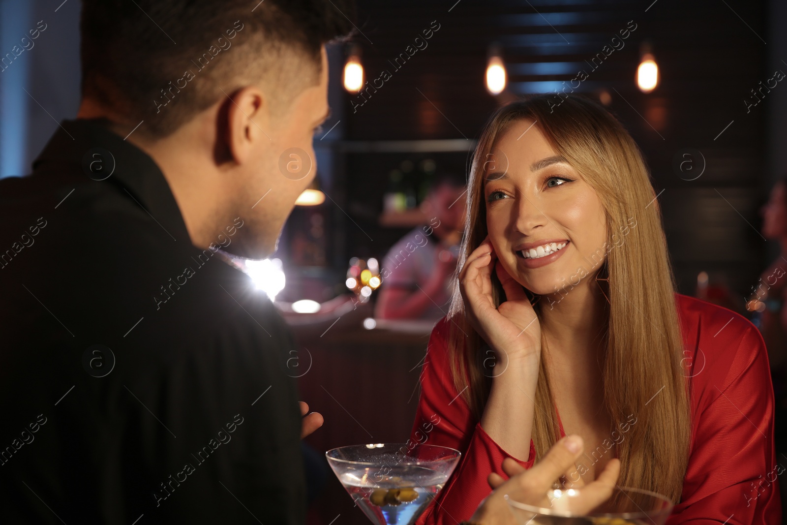 Photo of Man and woman flirting with each other in bar