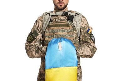 Photo of Soldier in military uniform with Ukrainian flag on white background, closeup