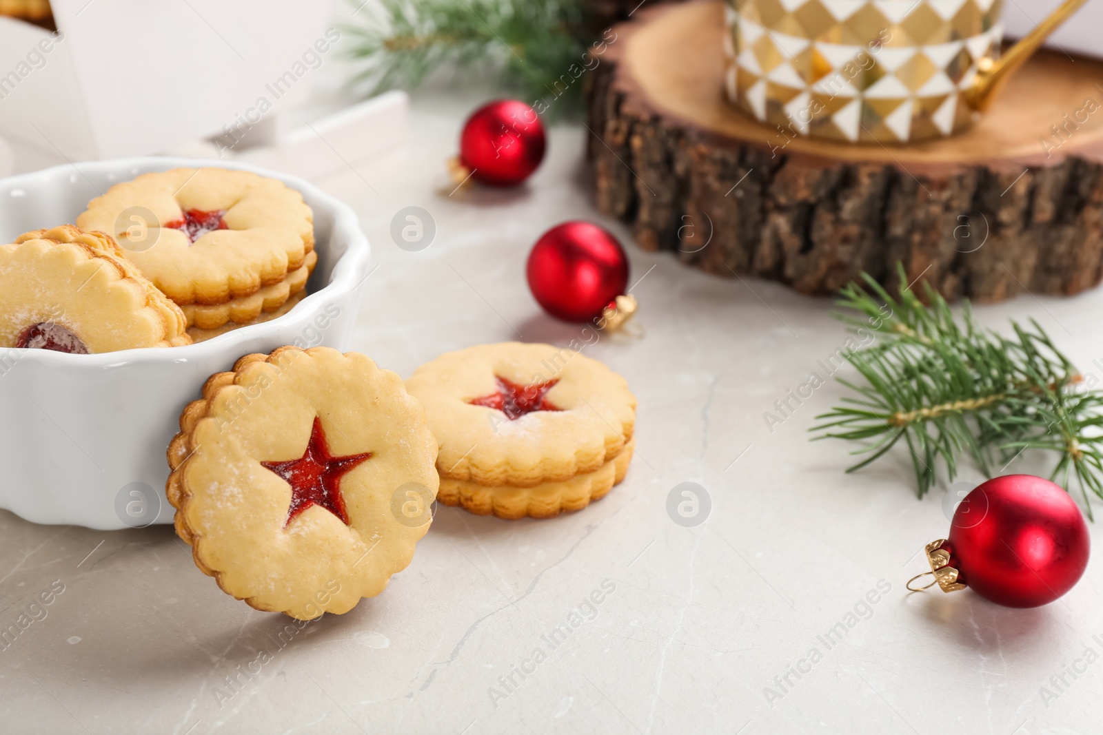Photo of Traditional Christmas Linzer cookies with sweet jam and bowl on table