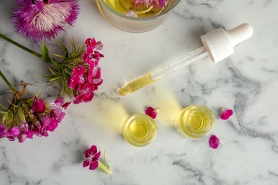 Photo of Flat lay composition with essential oils and flowers on marble background