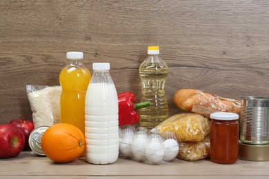 Many different donation food on wooden table