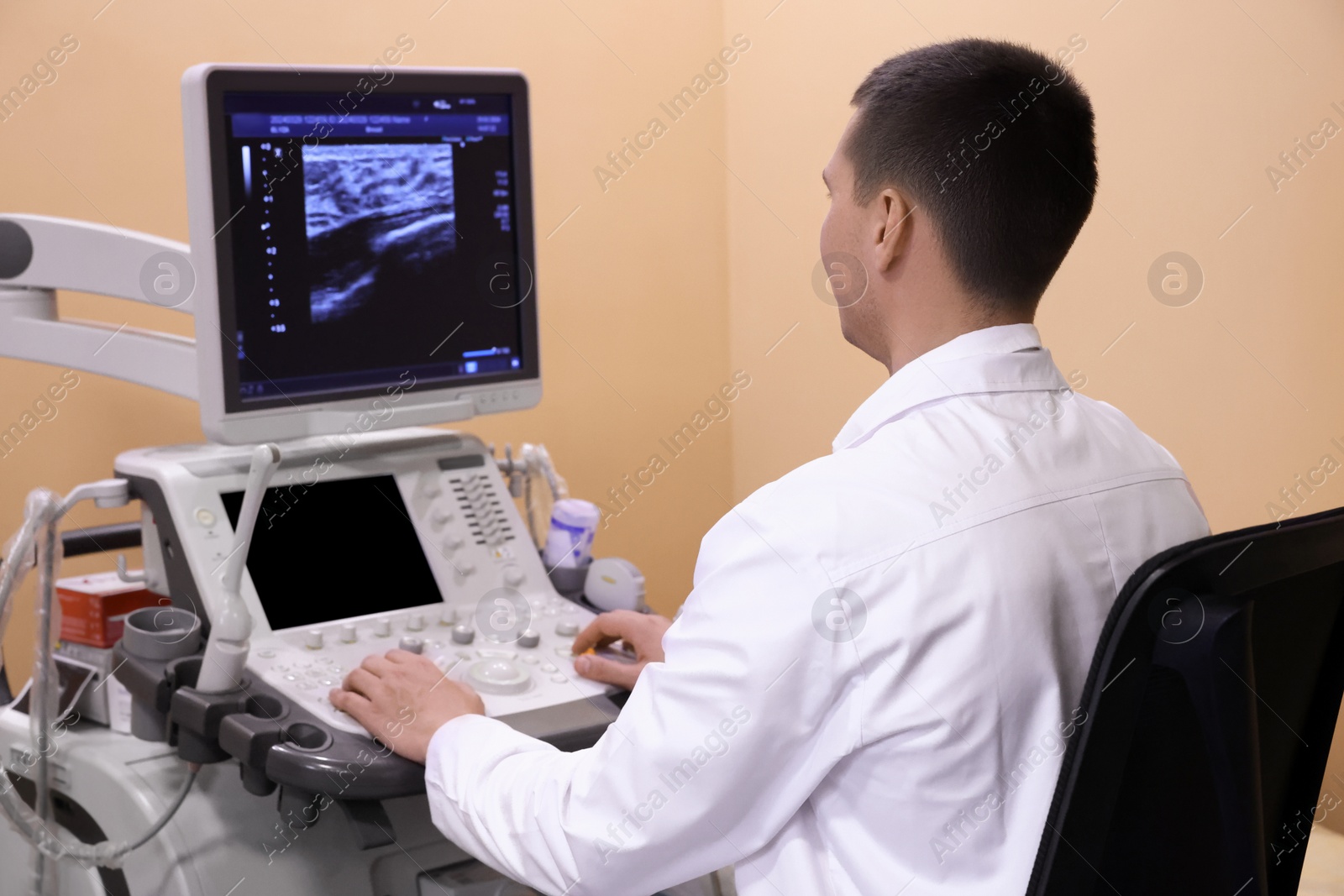 Photo of Mammologist working with ultrasound machine in clinic