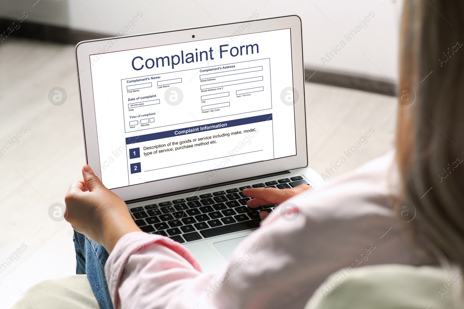 Image of Woman filling online complaint form via laptop indoors, closeup