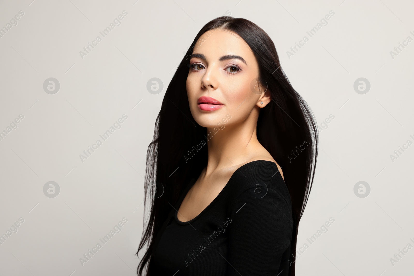 Photo of Portrait of beautiful young woman on light grey background