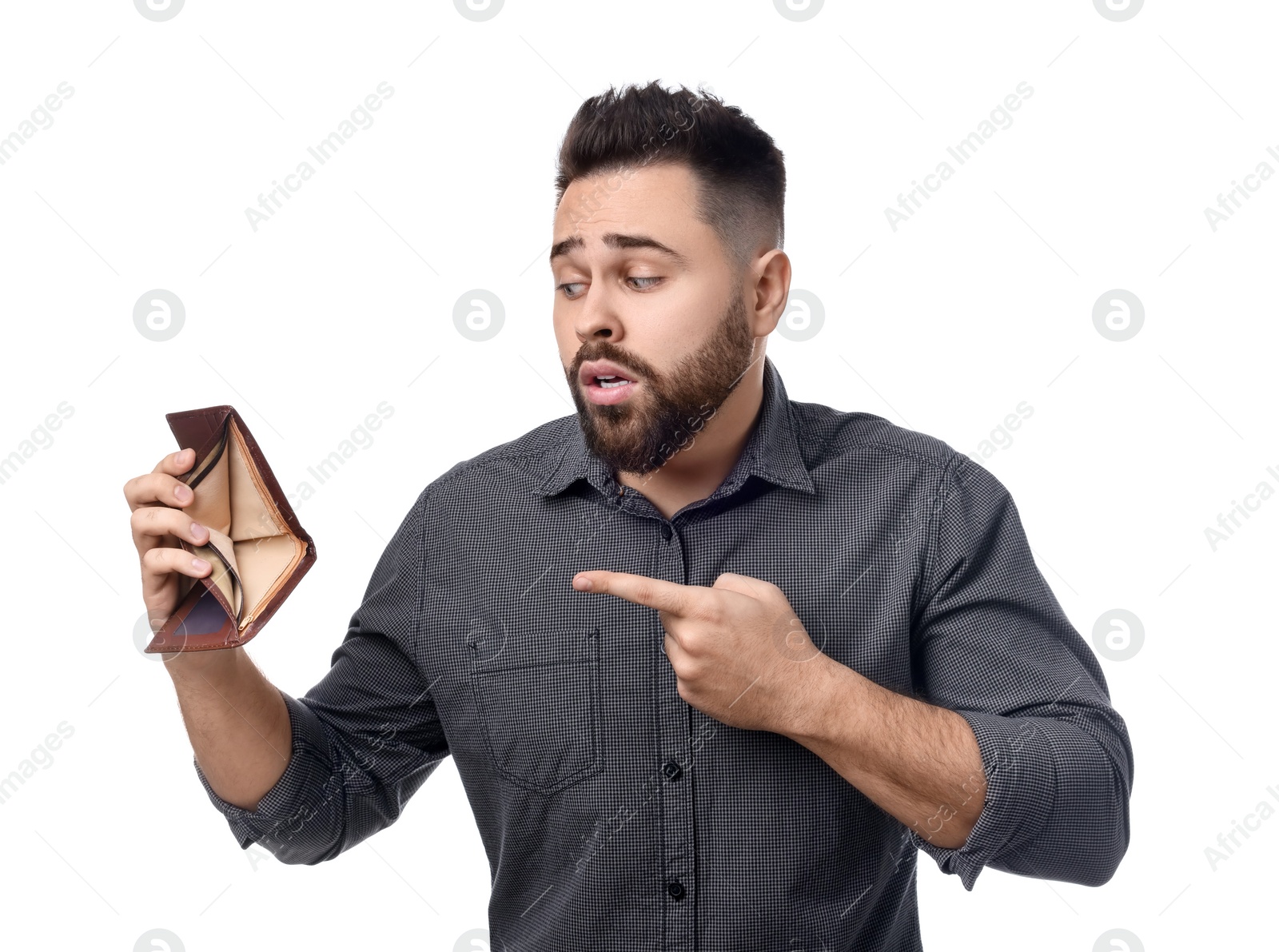 Photo of Confused man pointing at empty wallet on white background