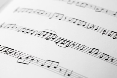 Sheet of paper with music notes as background, closeup