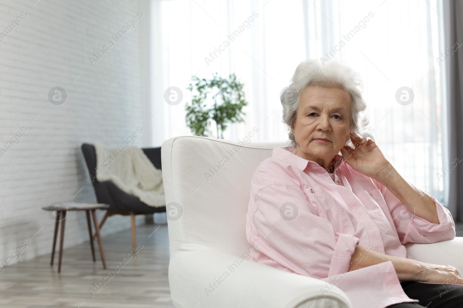 Photo of Portrait of mature woman in living room