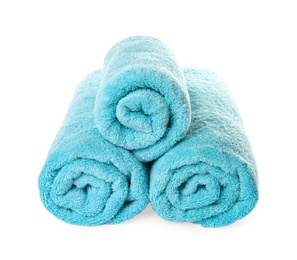 Rolled clean turquoise towels on white background