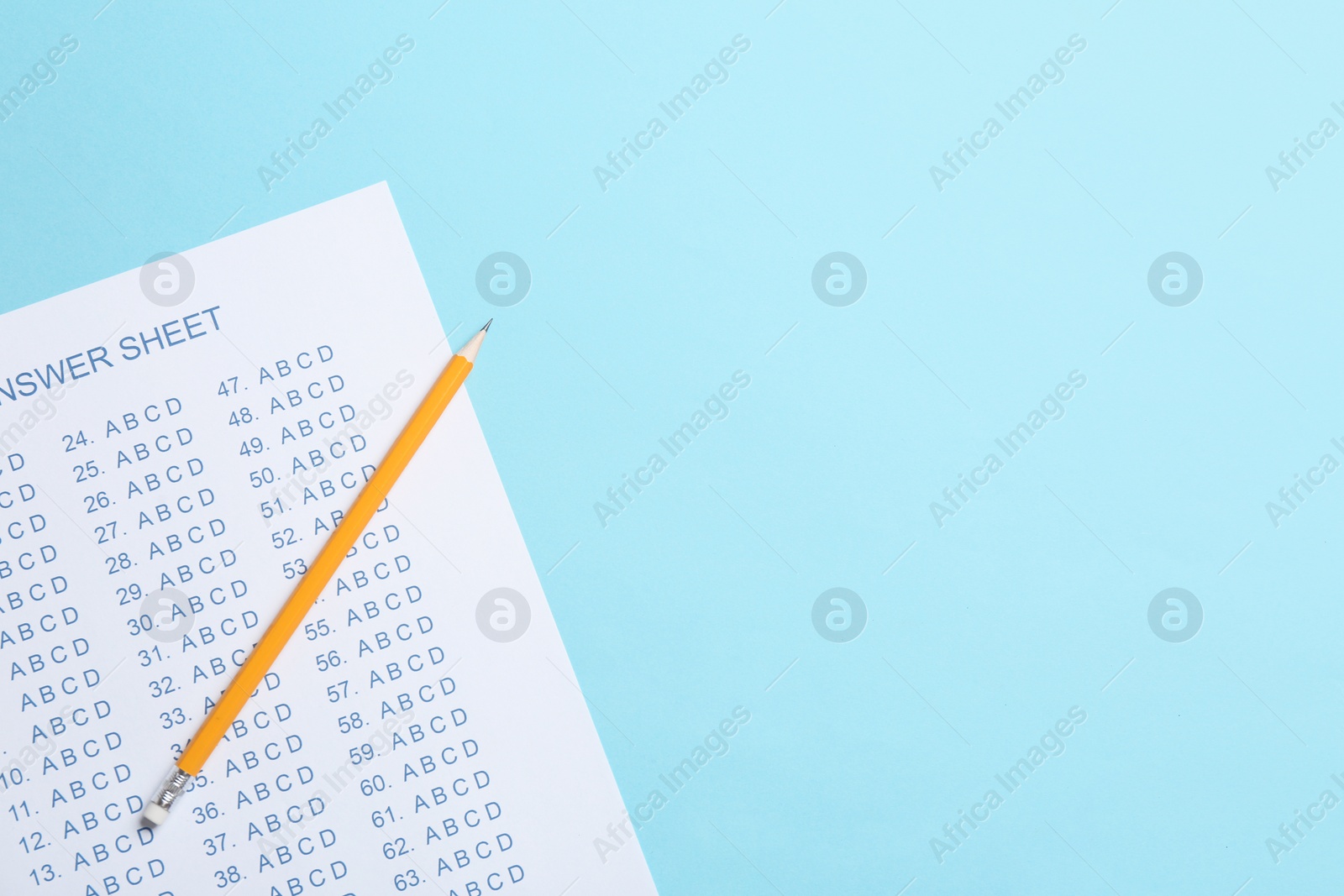 Photo of Answer sheet and pencil on color background, top view with space for text