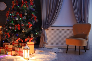 Photo of Stylish room interior with decorated Christmas tree