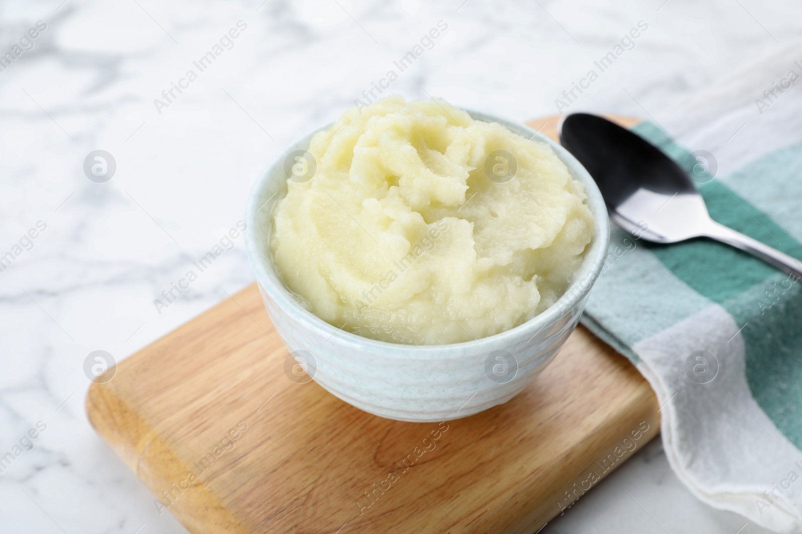 Photo of Bowl with tasty puree food served on white marble table