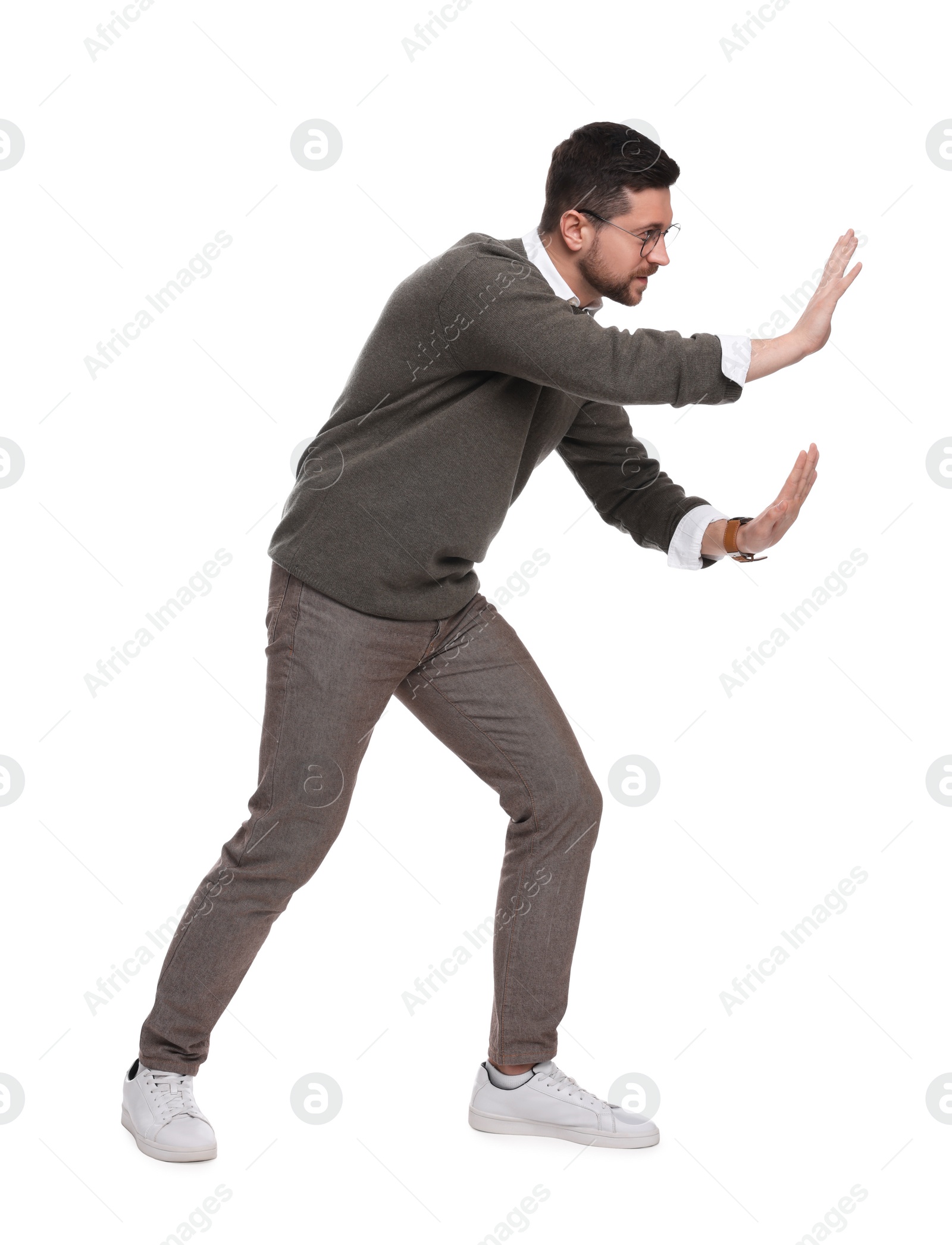 Photo of Handsome bearded businessman in eyeglasses evading something on white background