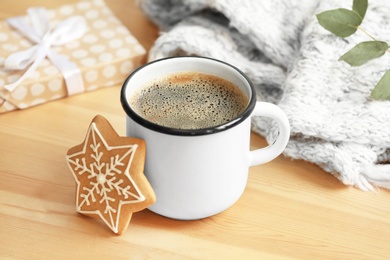 Composition with cup of hot winter drink and Christmas cookie on table. Cozy season