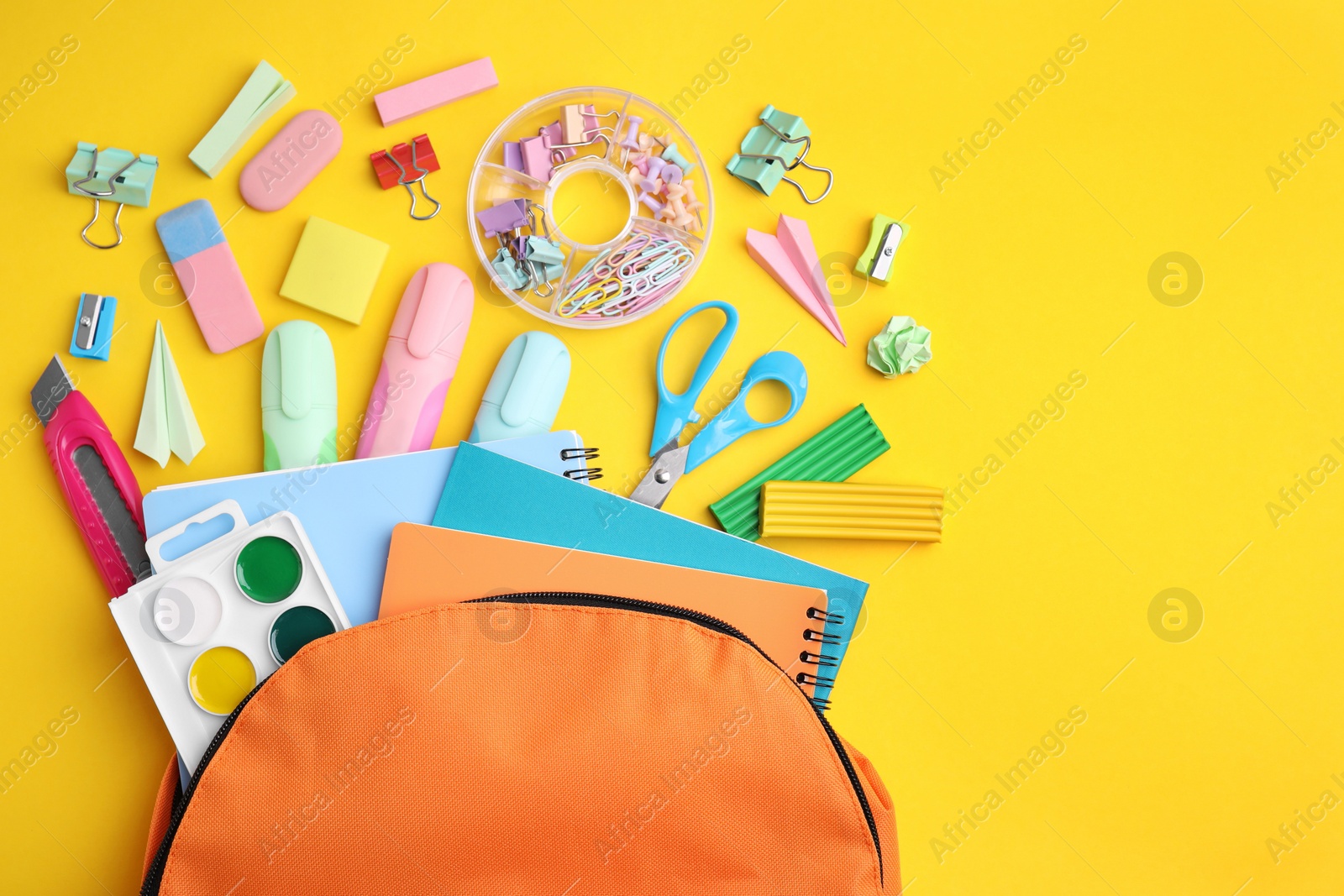 Photo of Flat lay composition with different school stationery on yellow background. Back to school