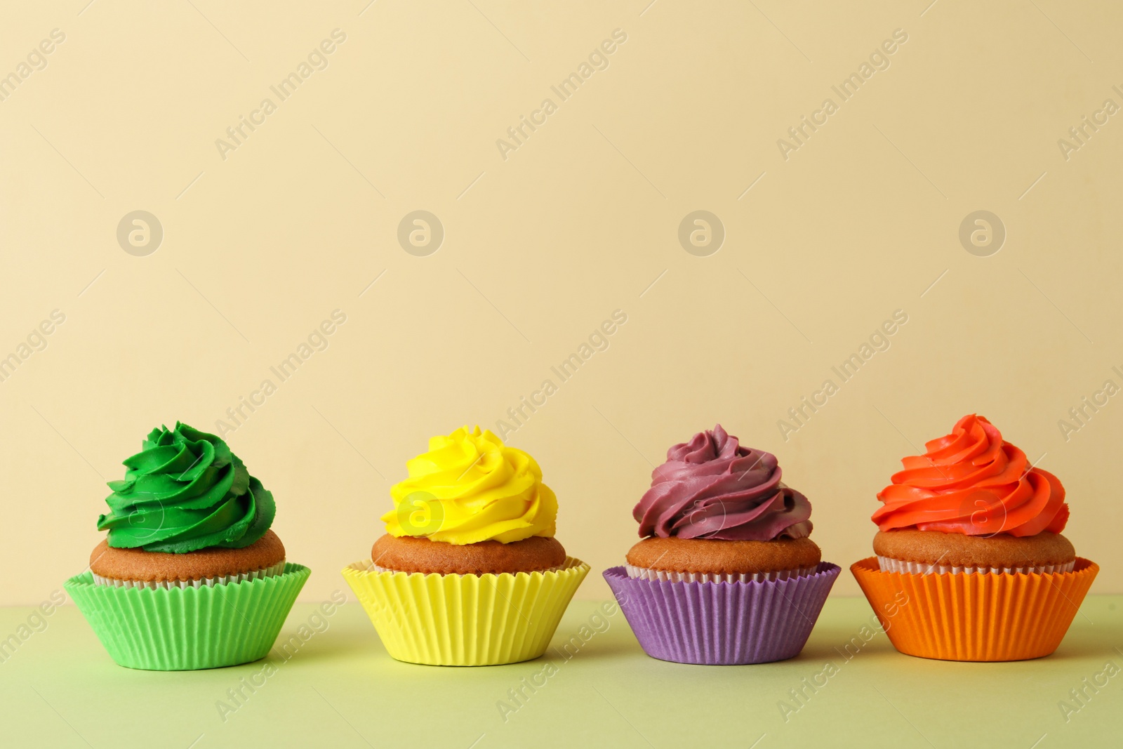 Photo of Different delicious cupcakes on color background, space for text