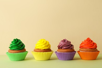 Different delicious cupcakes on color background, space for text