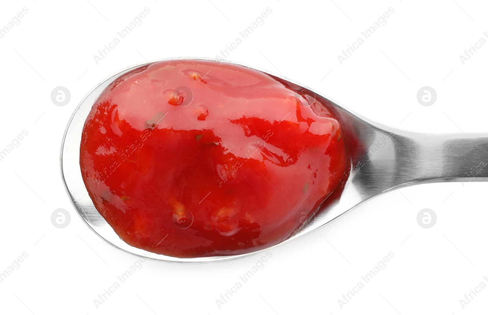 Photo of Spoon with spicy chili sauce on white background, top view