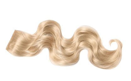 Lock of blonde wavy hair on white background, top view