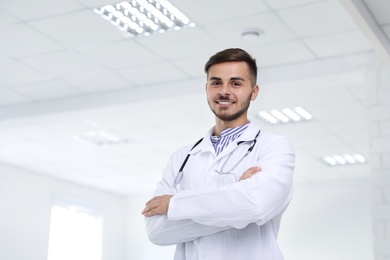Photo of Portrait of male doctor in coat at workplace