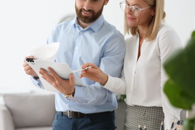 Businesspeople working with documents in office, closeup