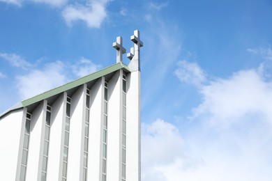 Photo of Exterior of modern church against blue sky with clouds