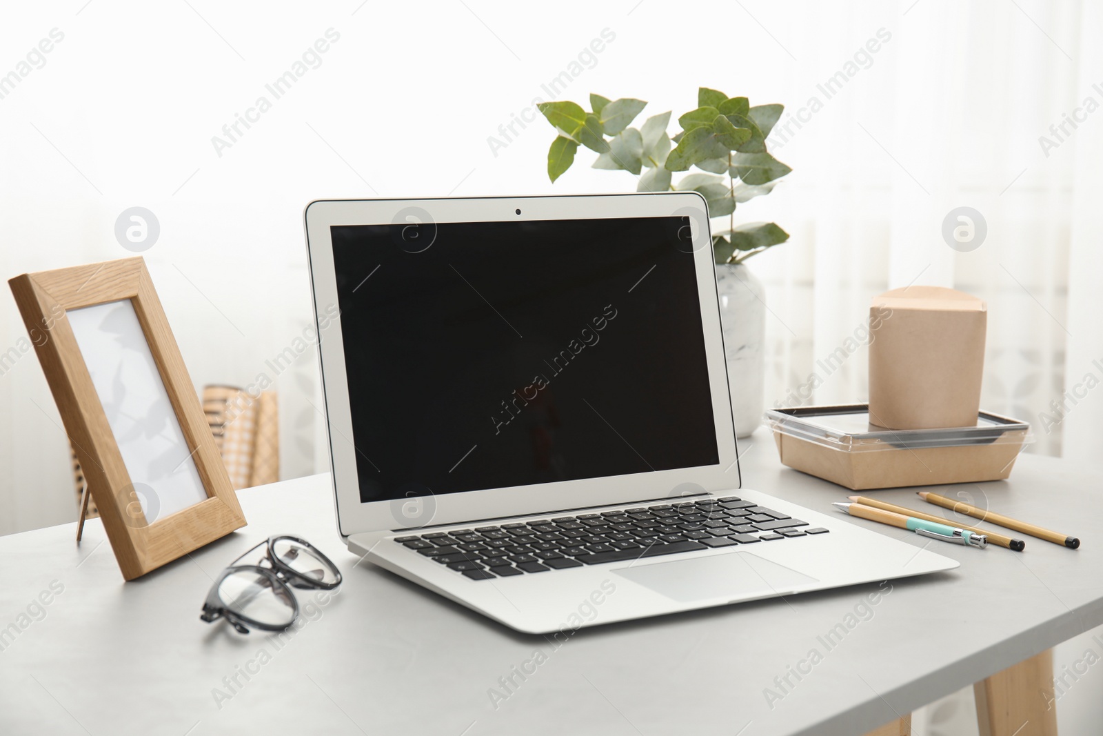 Photo of Cozy blogger workplace with laptop at home