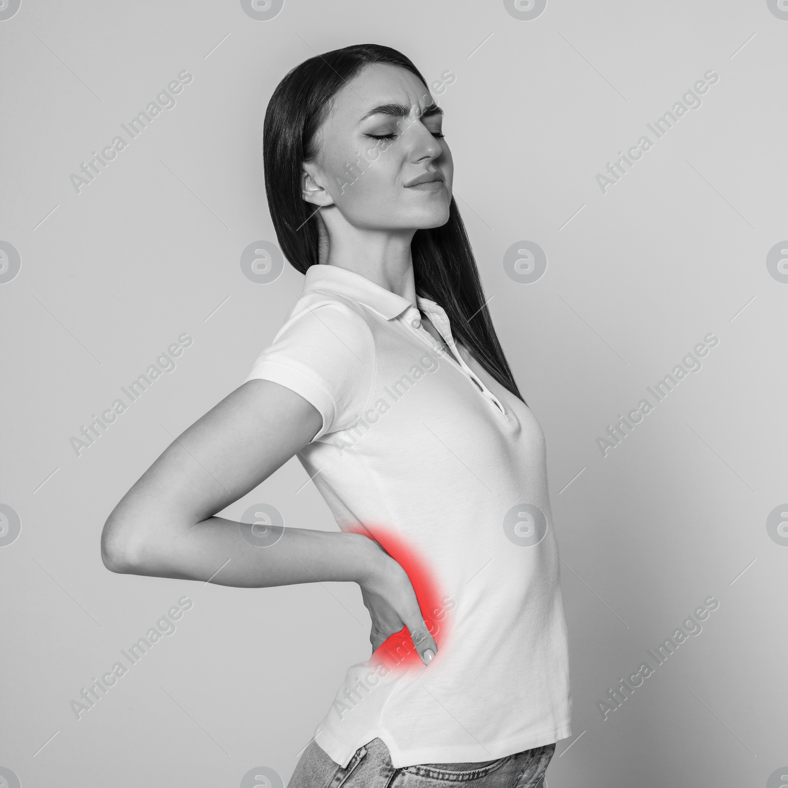 Image of Woman suffering from rheumatism on light background. Black and white effect with red accent in painful area