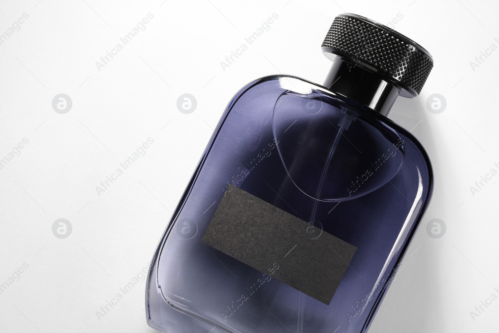 Photo of Luxury men`s perfume in bottle on white background, top view. Space for text