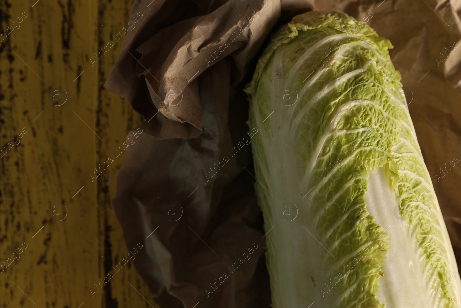 Photo of Fresh ripe Chinese cabbage on wooden table, top view. Space for text