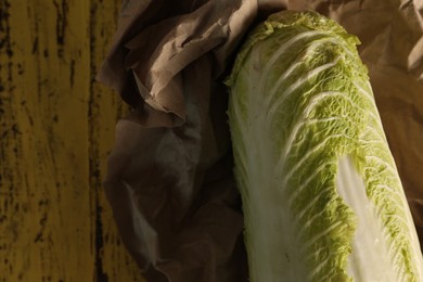 Fresh ripe Chinese cabbage on wooden table, top view. Space for text