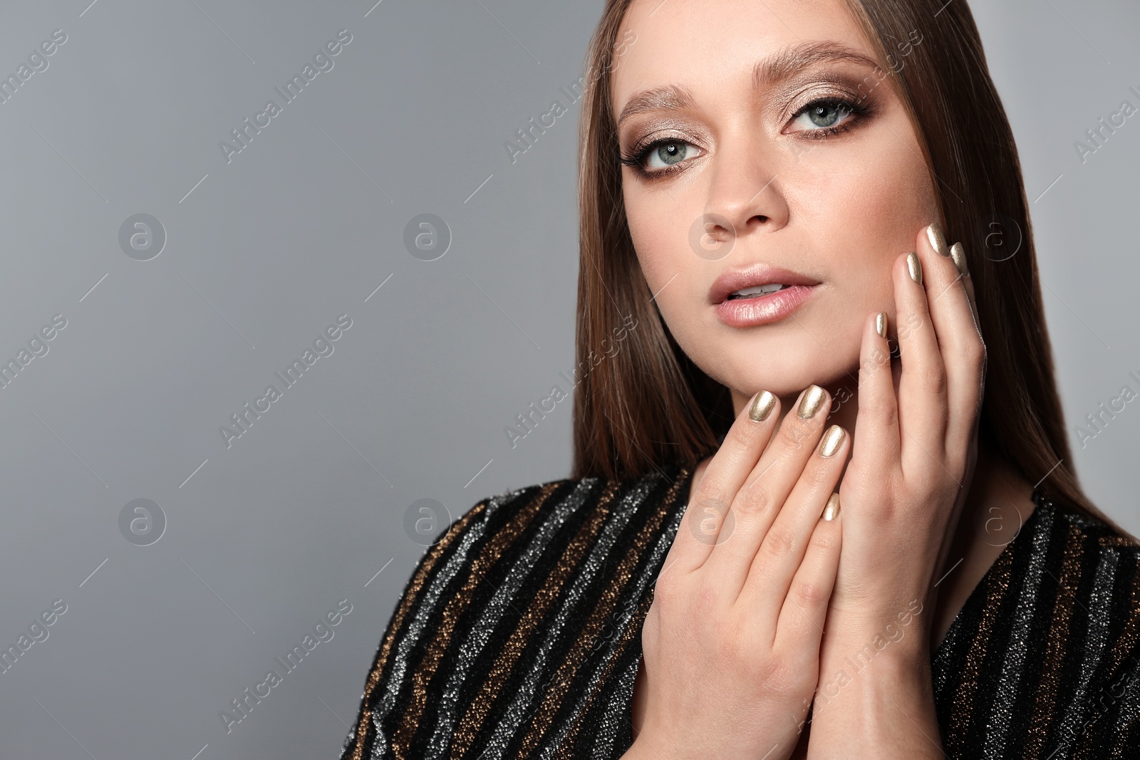 Photo of Beautiful woman with stylish nail polish on grey background, space for text