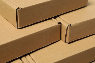 Photo of Many closed cardboard boxes as background, closeup