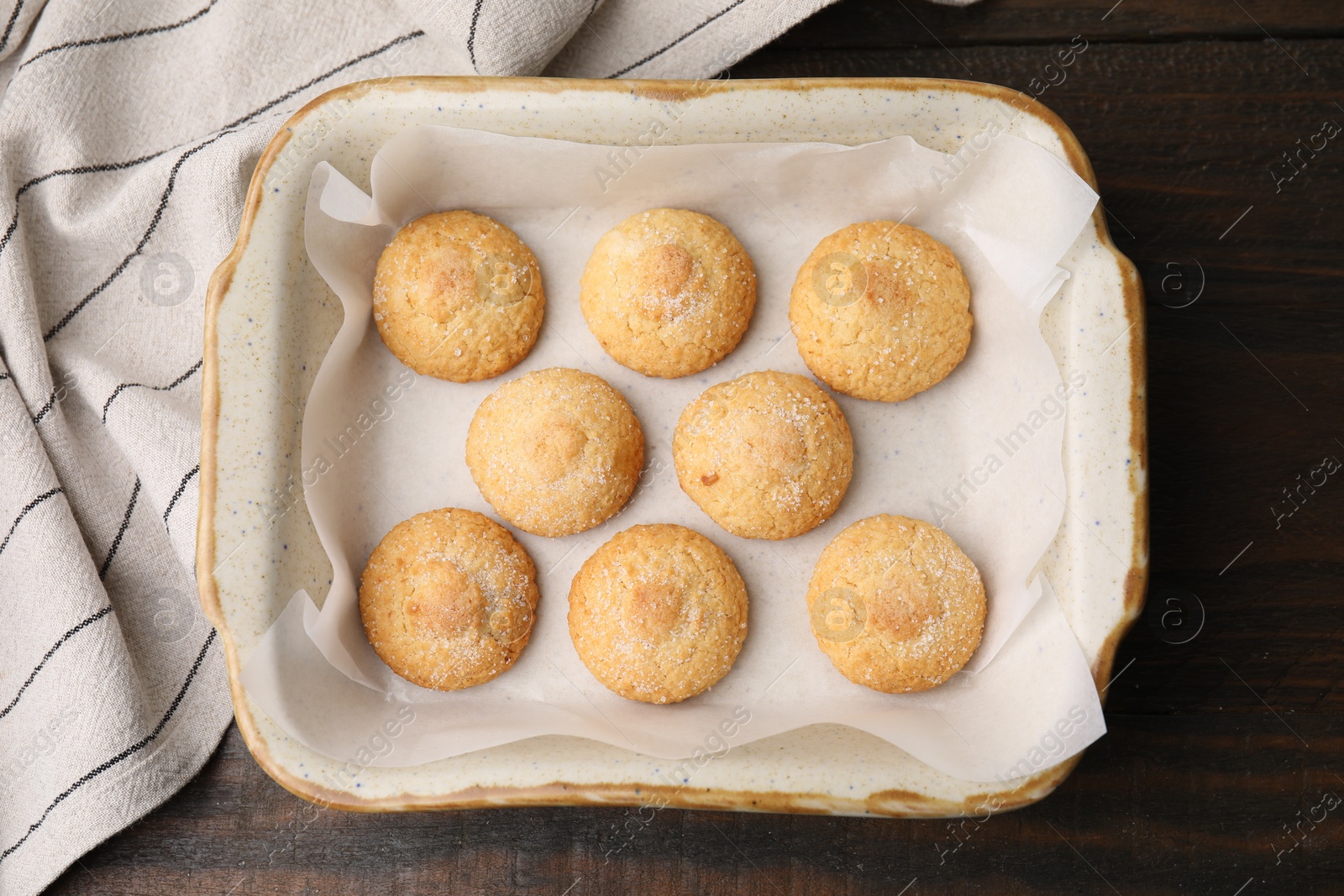 Photo of Tasty sweet sugar cookies in baking dish on wooden table, top view