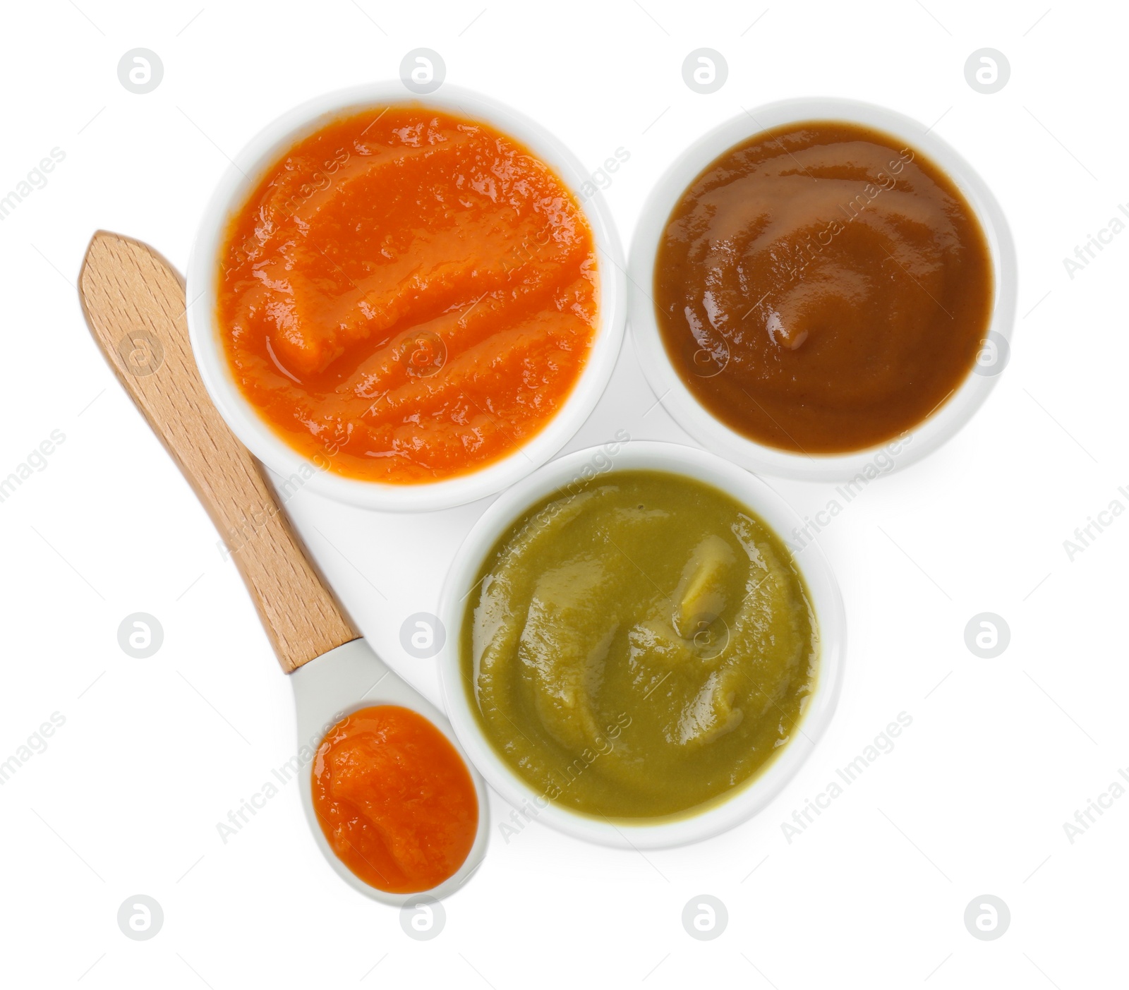 Photo of Bowls with healthy baby food and spoon isolated on white, top view