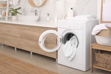 Stylish bathroom interior with modern washing machine