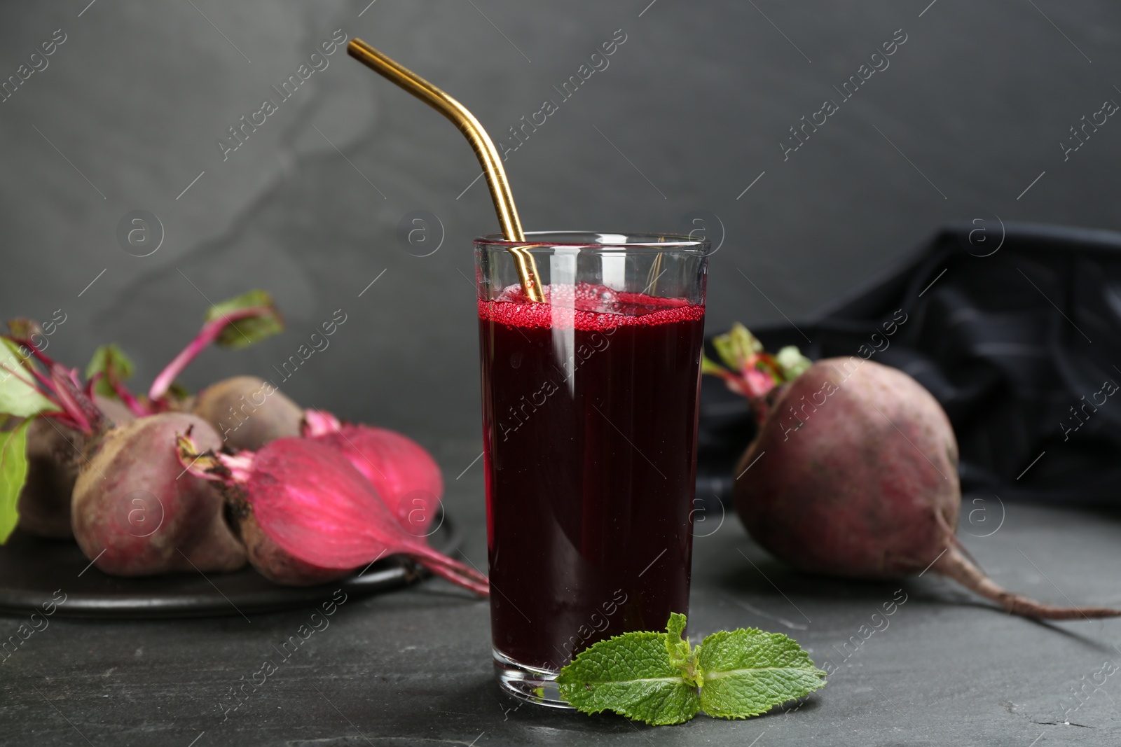 Photo of Freshly made beet juice on black table