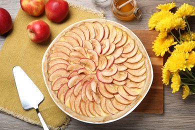 Flat lay composition with tasty apple pie on wooden table