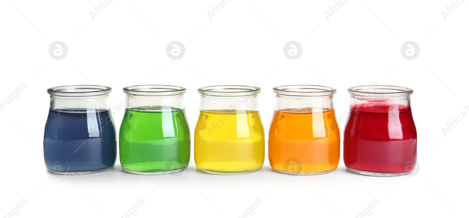 Photo of Tasty jelly desserts in glass jars on white background