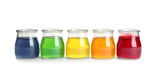 Photo of Tasty jelly desserts in glass jars on white background