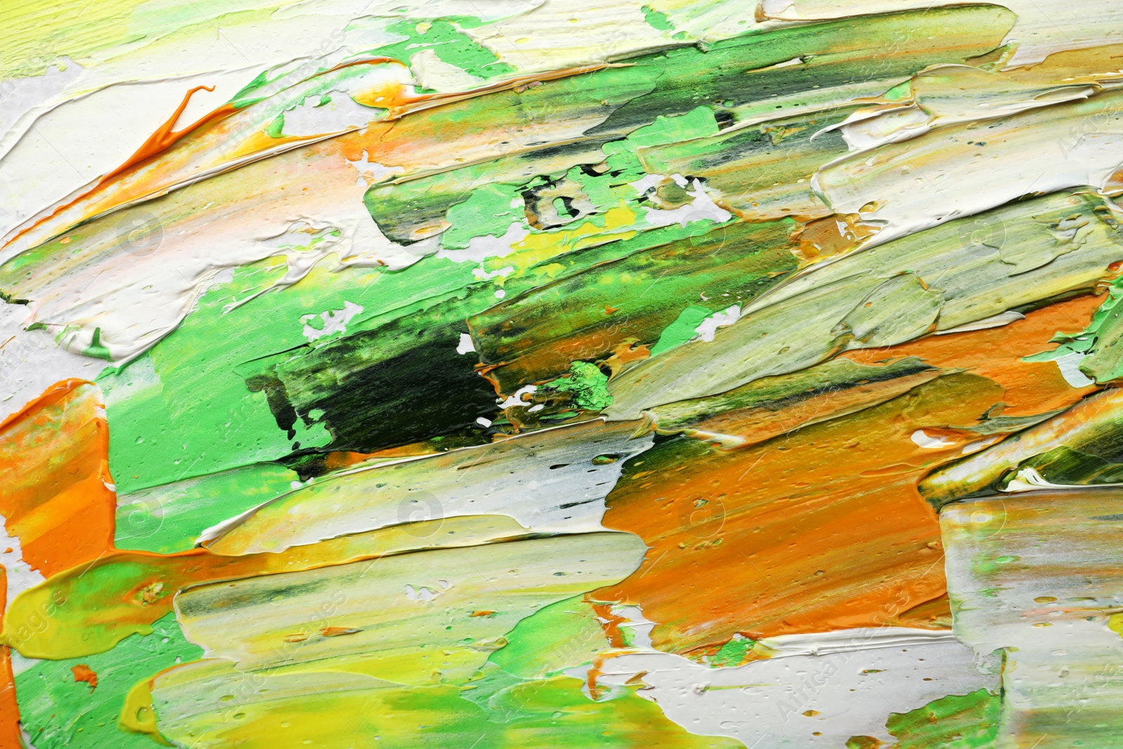 Photo of Beautiful strokes of colorful oil paints as background, closeup