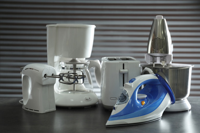 Photo of Set of modern home appliances on grey table