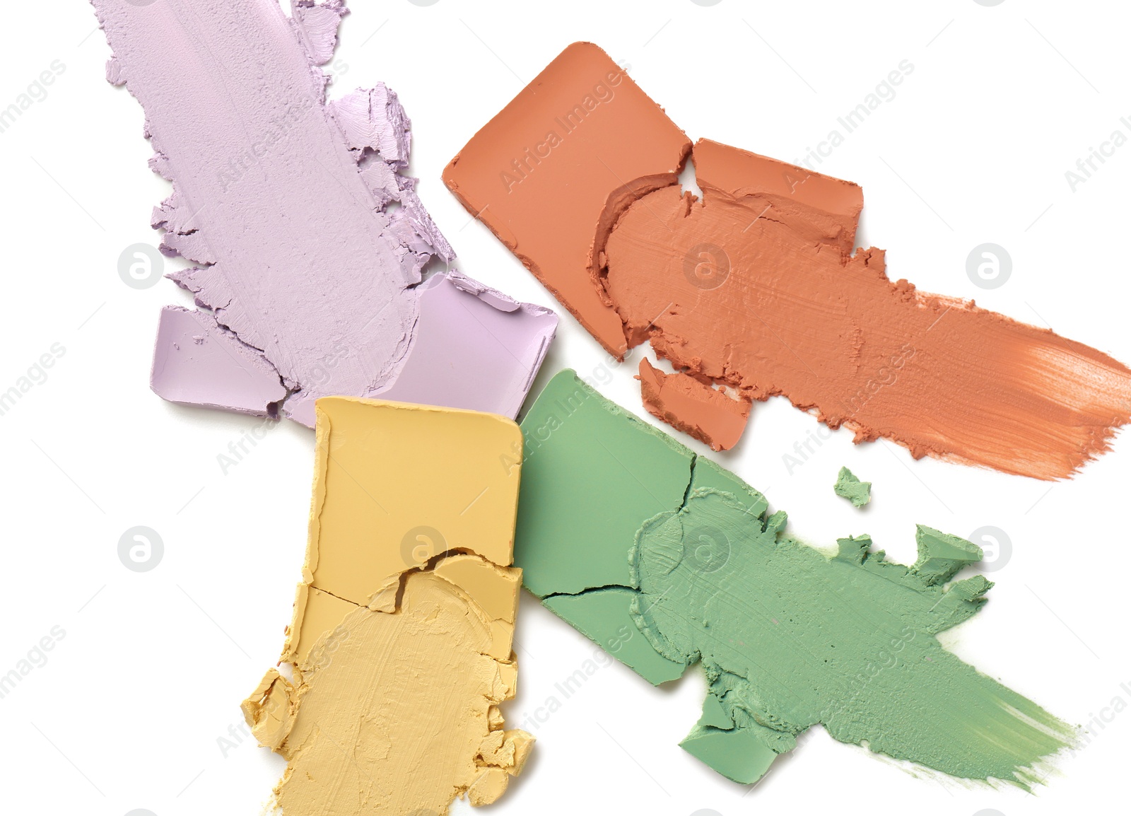 Photo of Samples of color correcting concealers isolated on white, top view