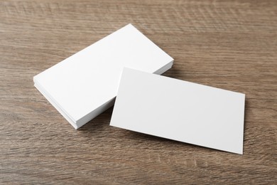 Photo of Blank business cards on wooden background. Mockup for design
