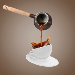 Pouring freshly brewed aromatic coffee from turkish pot into cup. Objects in air on dark beige background