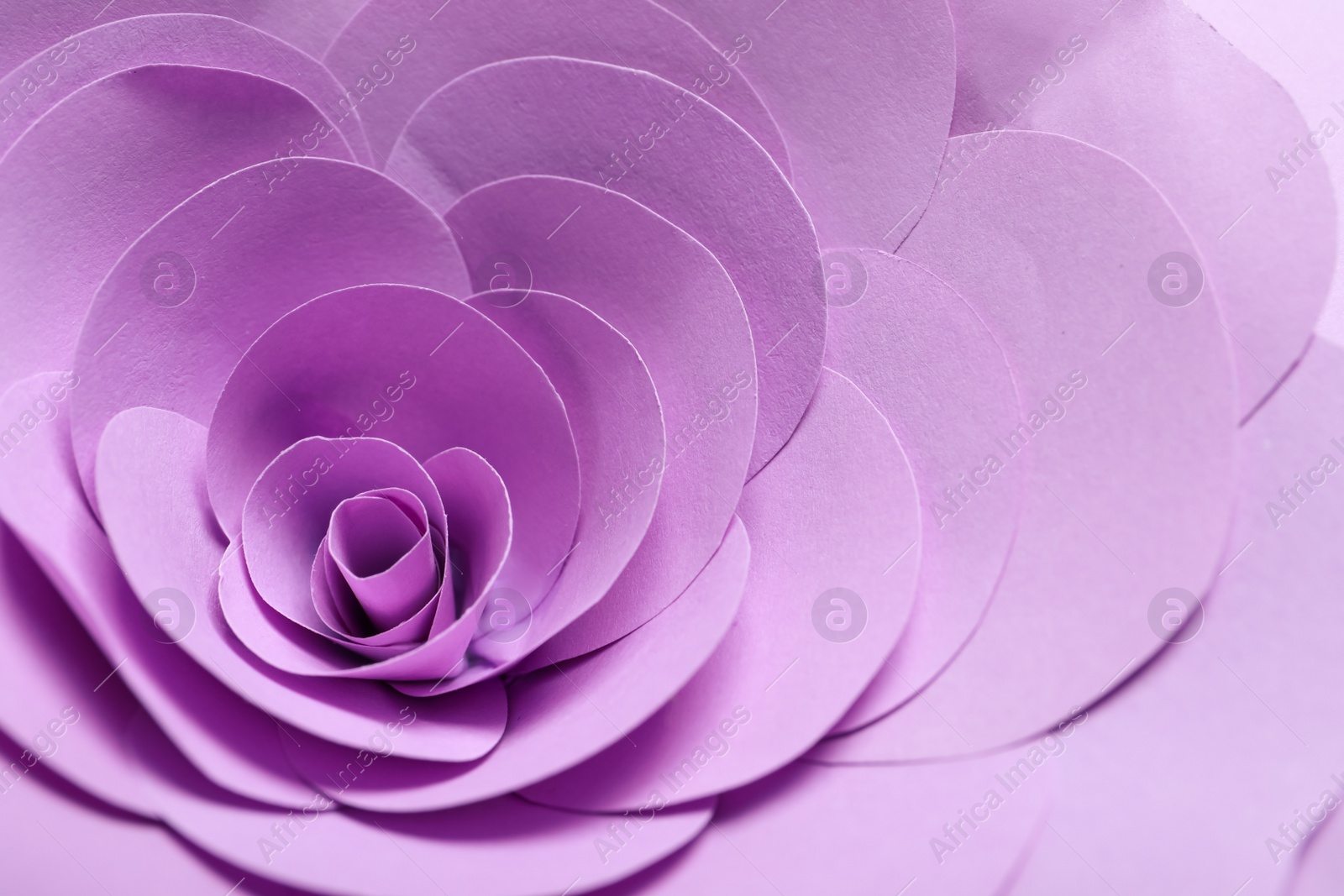Photo of Beautiful violet flower made of paper as background, closeup