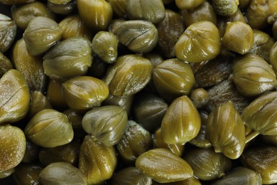 Photo of Closeup of pickled capers as background, top view