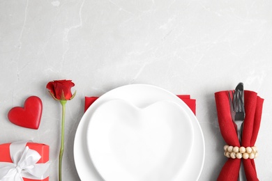 Photo of Romantic table setting on light grey background, flat lay with space for text. Valentine's day celebration