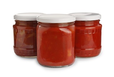 Photo of Glass jars of delicious canned lecho on white background