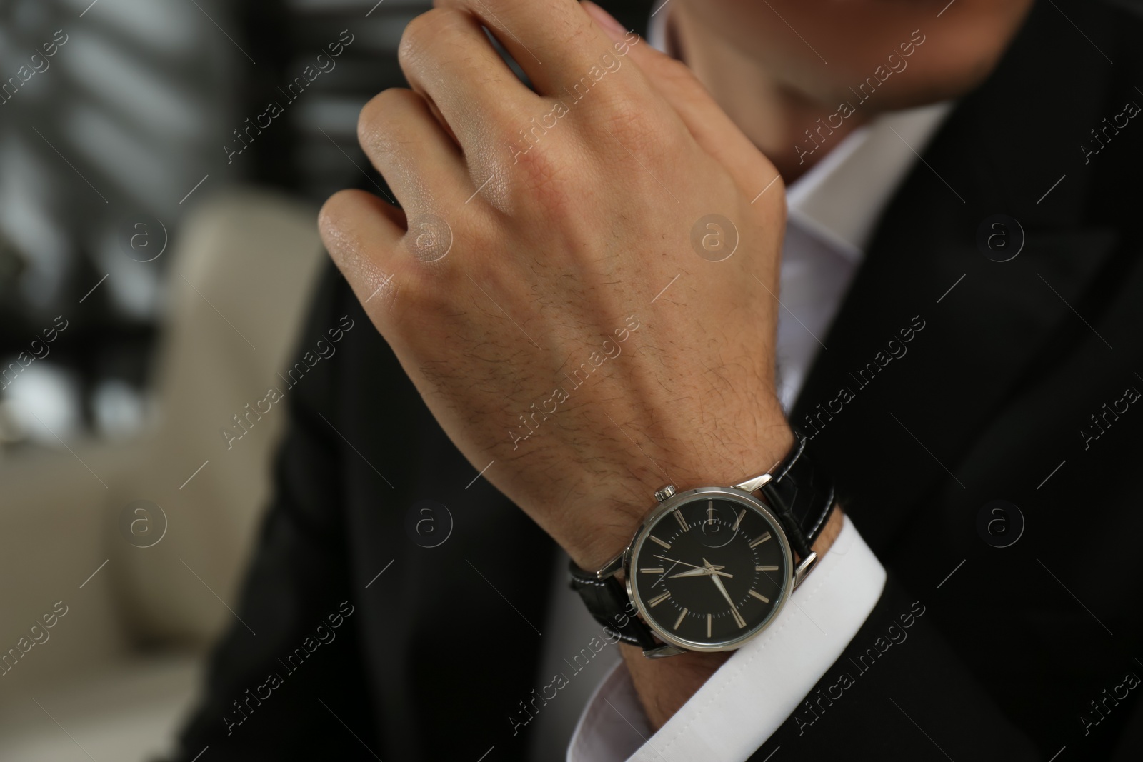 Photo of Businessman with luxury wrist watch indoors, closeup