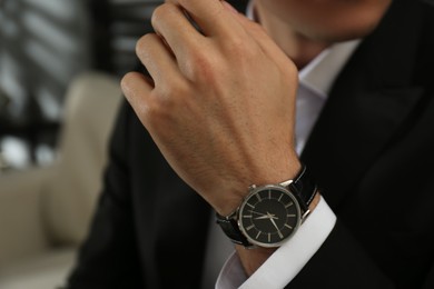 Photo of Businessman with luxury wrist watch indoors, closeup